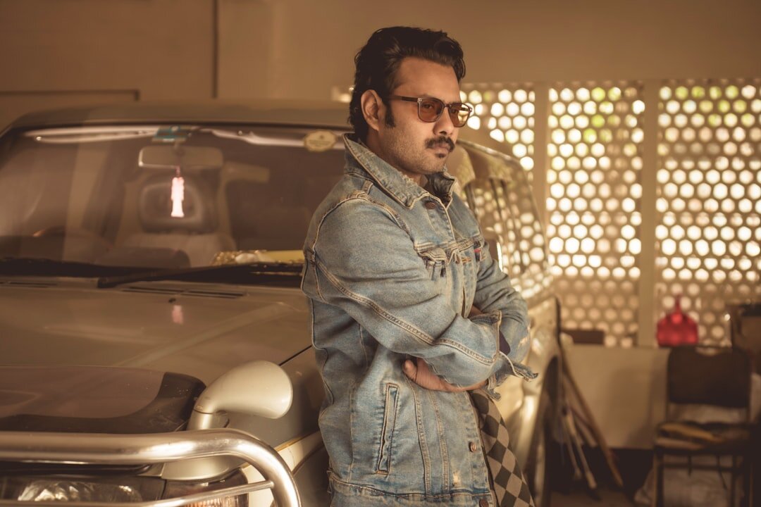 Uruguayan man in his 40s, automotive curator, wearing a tailored blazer, studio portrait