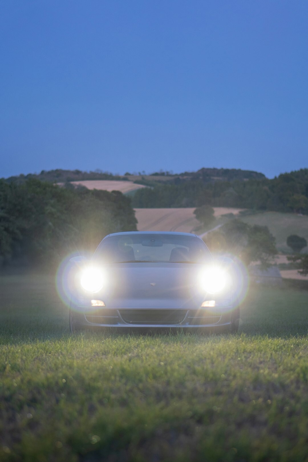 Black and gold hypercar driving on a coastal road in Punta del Este at dusk